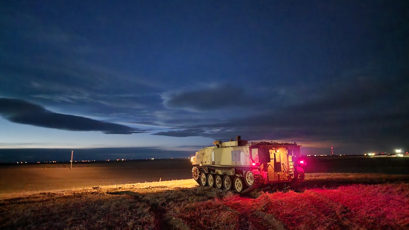 FV432 Mk1 in a field at dusk with lights on